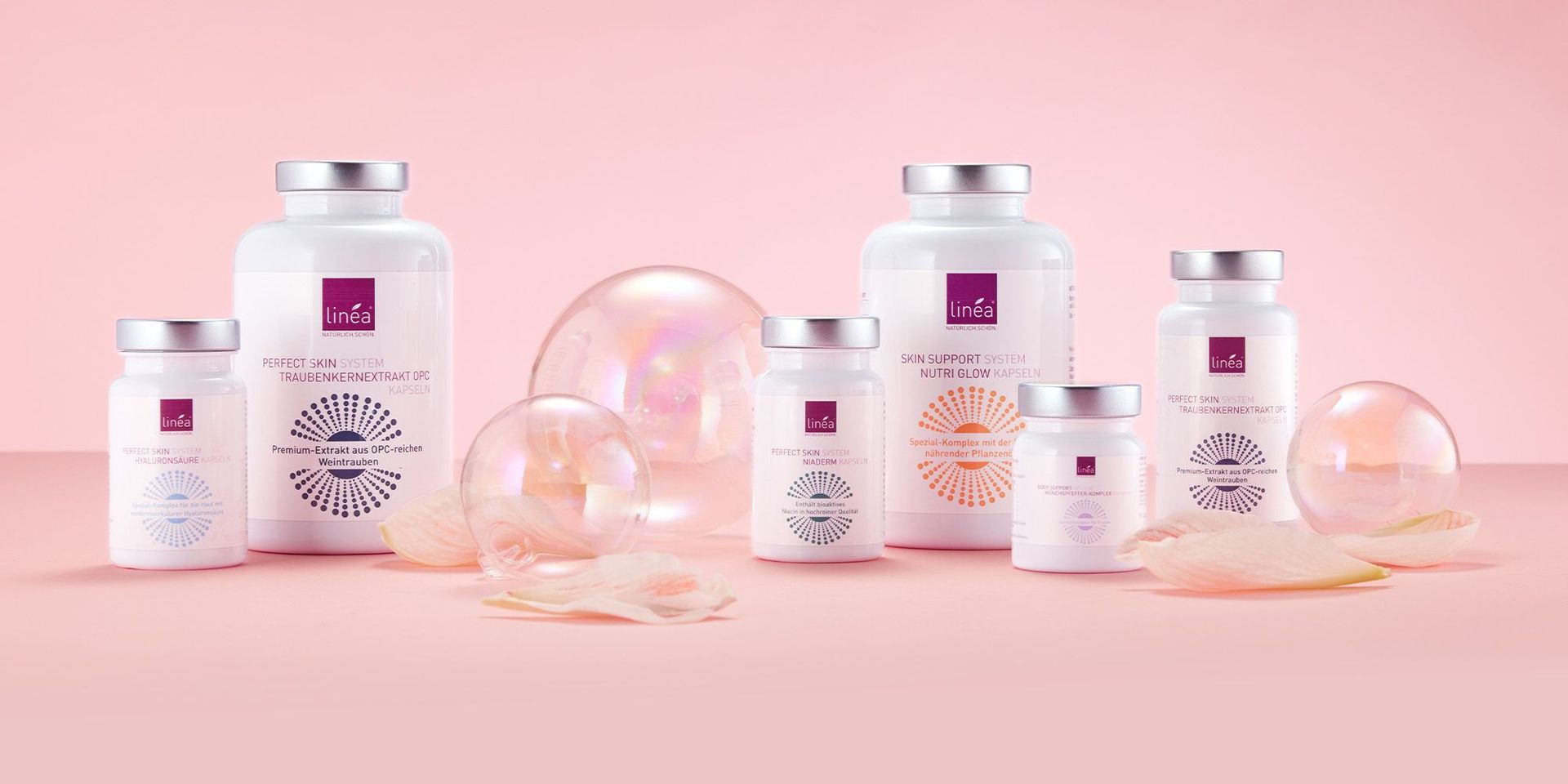 Verschiedene Produkte von Linea vor einem rosanen Hintergrund